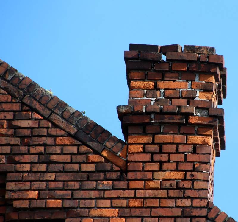Damaged chimney on an Westford home showing cracks and missing mortar
